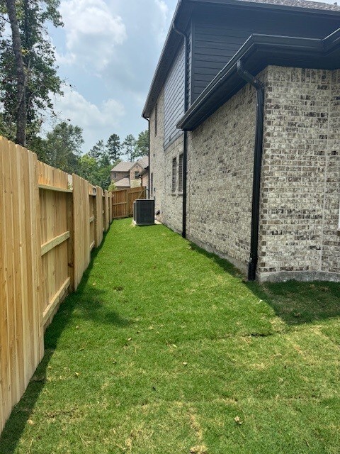 16147 Rustling Woods Rd, Conroe, TX 77302 - view of yard with cooling unit