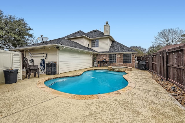 view of swimming pool with an in ground hot tub, a patio, and pool water feature