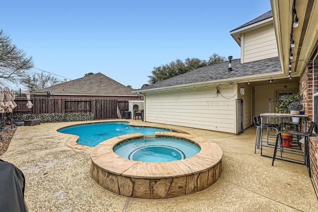 view of pool featuring a patio and an in ground hot tub