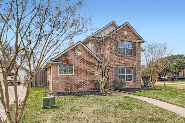 traditional-style home with a front lawn, a chimney, fence, and brick siding