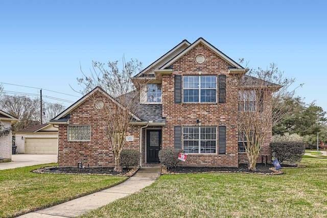 traditional-style home featuring brick siding and a front yard