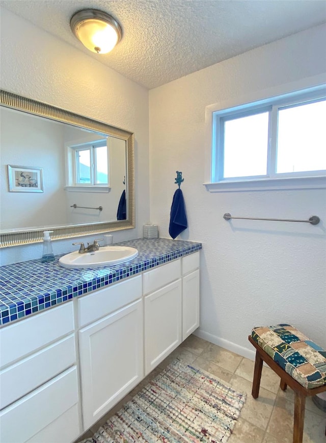 bathroom featuring a textured ceiling and vanity