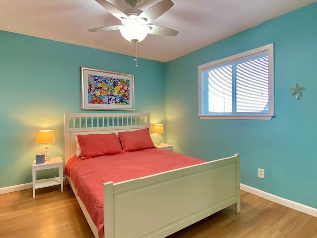 bedroom with ceiling fan and light hardwood / wood-style floors