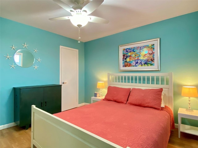 bedroom with hardwood / wood-style flooring and ceiling fan