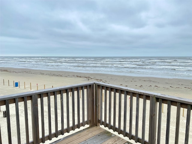 view of home's community featuring a water view and a beach view