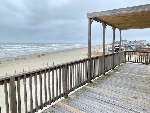 view of community with a water view and a view of the beach