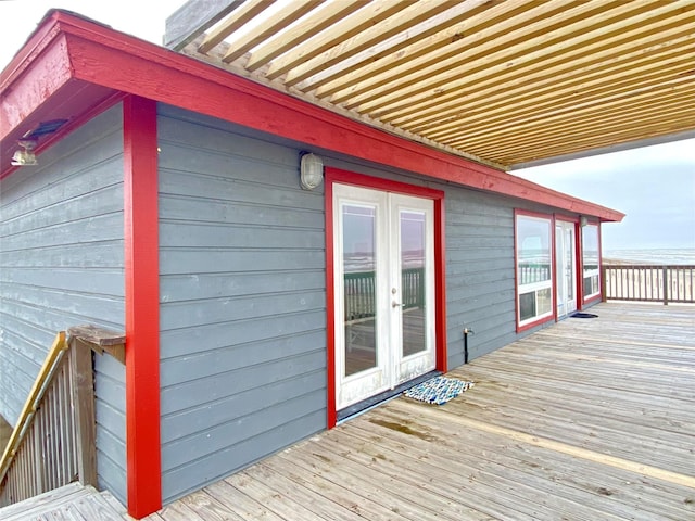 deck with french doors and a pergola