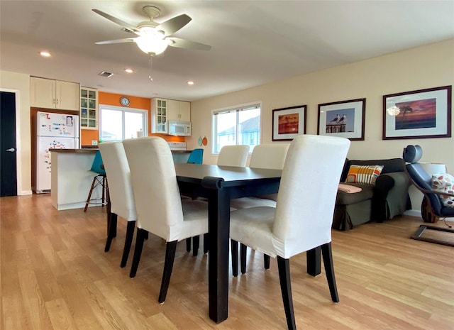 dining area featuring ceiling fan and light hardwood / wood-style flooring