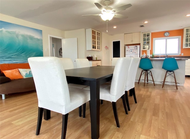 dining room featuring ceiling fan and light hardwood / wood-style flooring