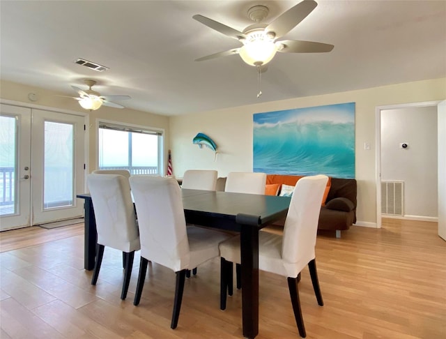 dining area with light wood-type flooring, french doors, and ceiling fan