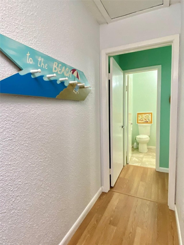 corridor with hardwood / wood-style floors