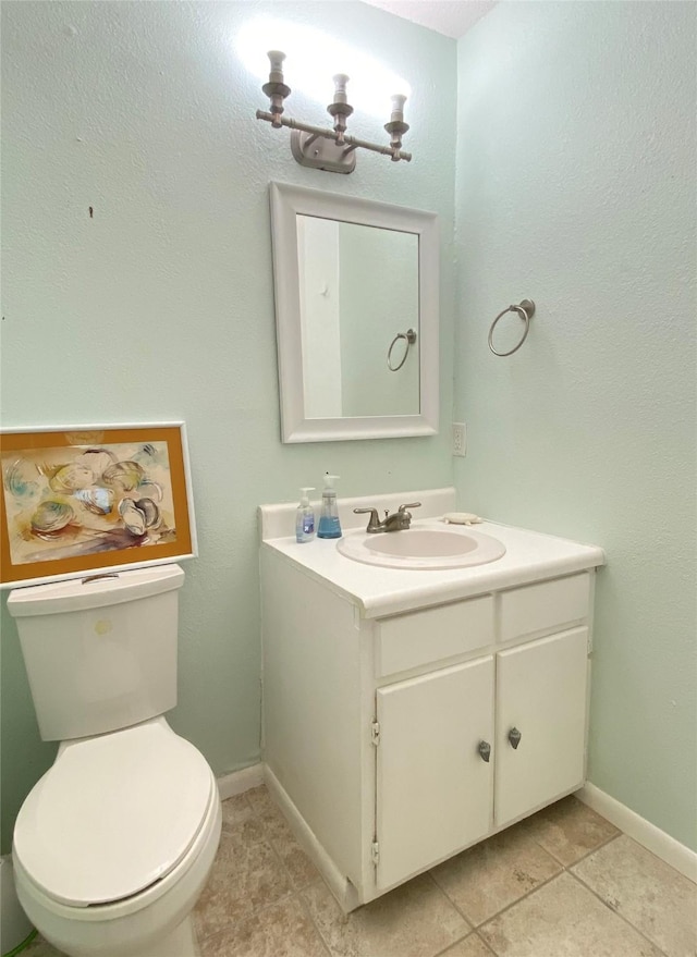 bathroom featuring vanity, tile patterned flooring, and toilet