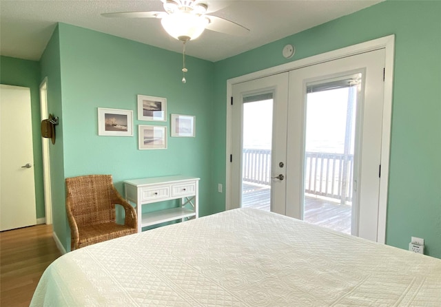 bedroom with french doors, hardwood / wood-style flooring, access to outside, and ceiling fan