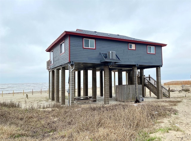 back of property featuring a water view