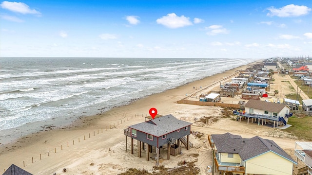 drone / aerial view with a water view and a beach view