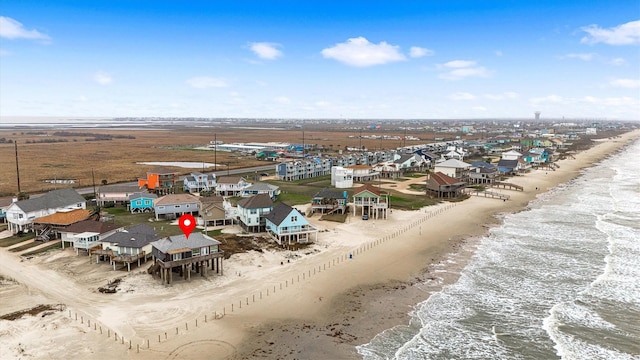 drone / aerial view featuring a water view and a view of the beach