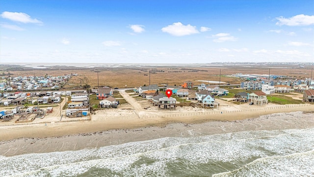 aerial view with a water view and a beach view