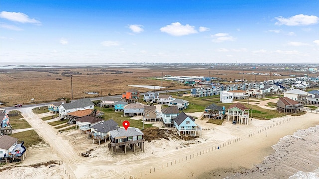 birds eye view of property featuring a water view and a view of the beach