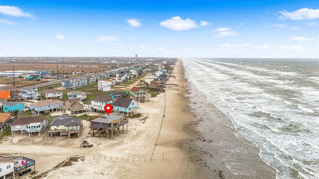 drone / aerial view featuring a water view and a view of the beach