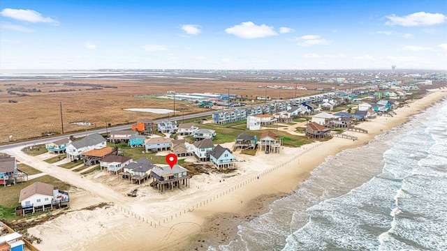 birds eye view of property featuring a water view and a view of the beach