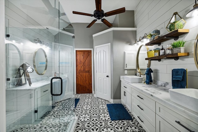 full bathroom with double vanity, a stall shower, ceiling fan, vaulted ceiling, and a sink