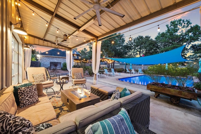 view of patio / terrace featuring fence, a ceiling fan, a fenced in pool, and an outdoor living space with a fire pit