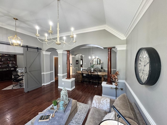 living room featuring a barn door, arched walkways, lofted ceiling, hardwood / wood-style flooring, and ornate columns