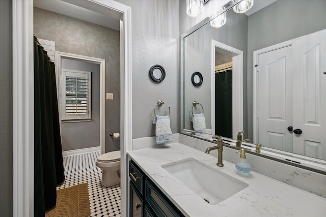 full bath with toilet, baseboards, and vanity