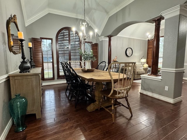 dining room with arched walkways, dark wood finished floors, lofted ceiling, and ornate columns