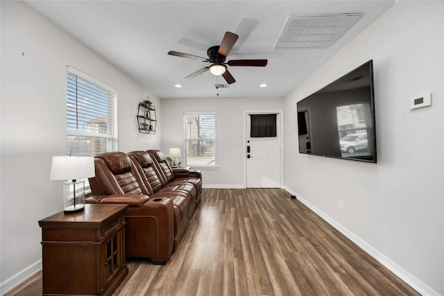 living room with hardwood / wood-style floors and ceiling fan