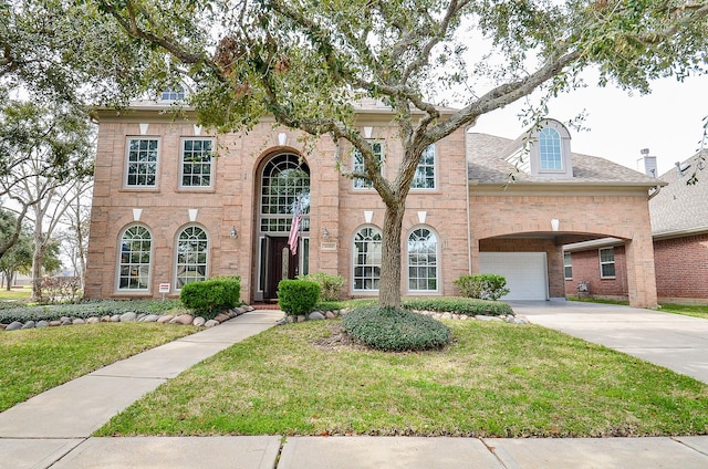 view of front of property featuring a garage and a front yard