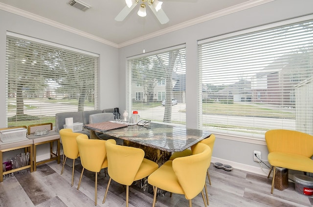 dining area with crown molding, ceiling fan, and hardwood / wood-style flooring