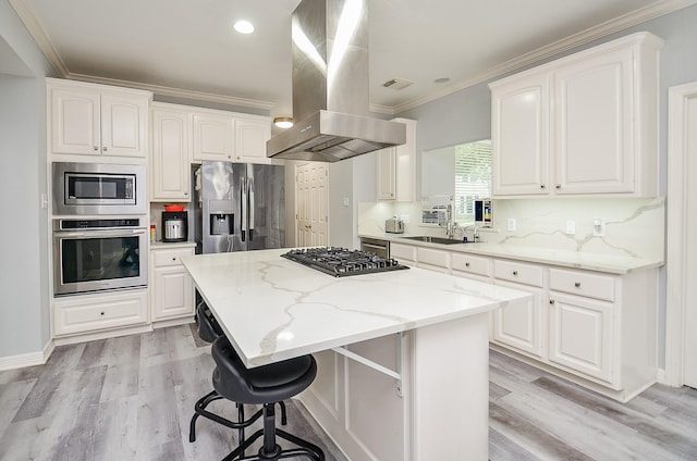 kitchen featuring white cabinetry, island range hood, and appliances with stainless steel finishes