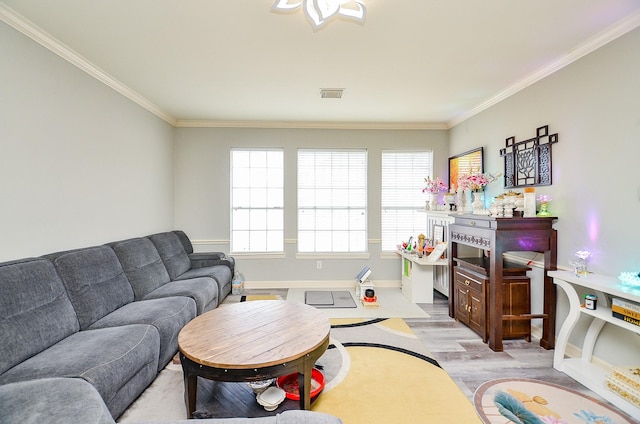 living room featuring crown molding and light hardwood / wood-style floors