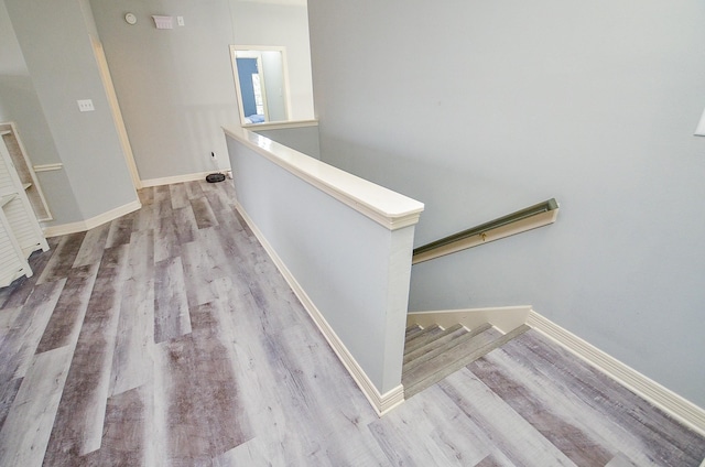 stairs with hardwood / wood-style floors