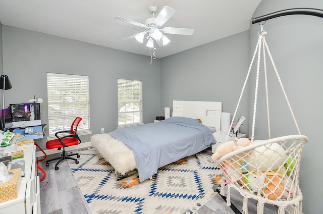 bedroom with ceiling fan and light hardwood / wood-style floors