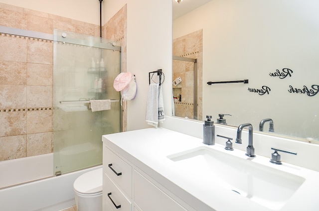 full bathroom featuring toilet, vanity, and shower / bath combination with glass door