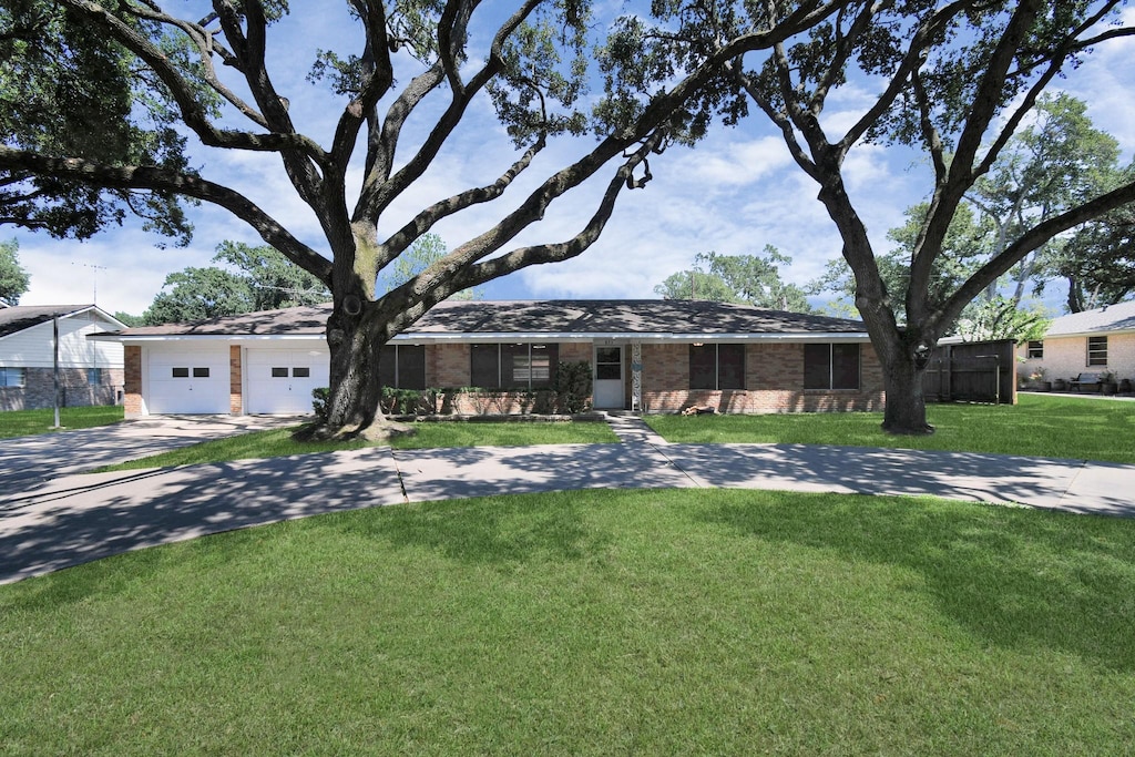 single story home with a garage and a front yard