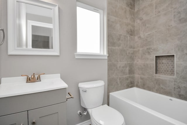 full bathroom with vanity, tiled shower / bath, and toilet