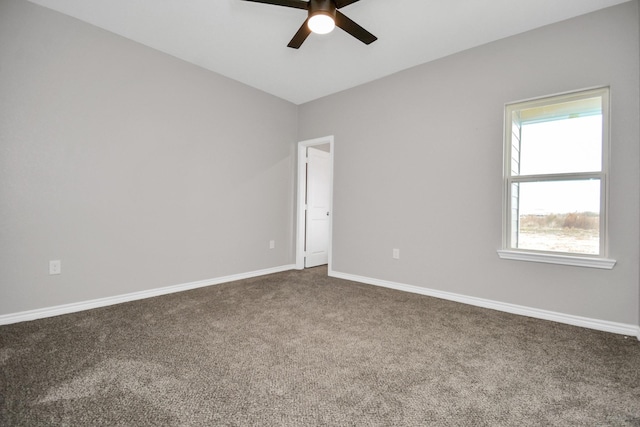 spare room featuring ceiling fan and carpet