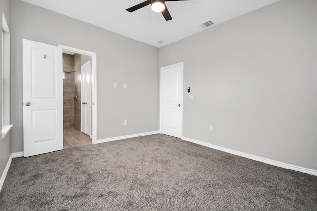 unfurnished bedroom featuring ensuite bath, ceiling fan, and carpet