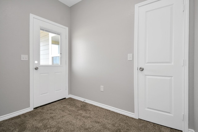 doorway to outside featuring dark carpet