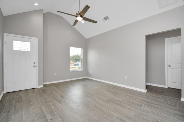 entryway with ceiling fan, high vaulted ceiling, and light wood-type flooring