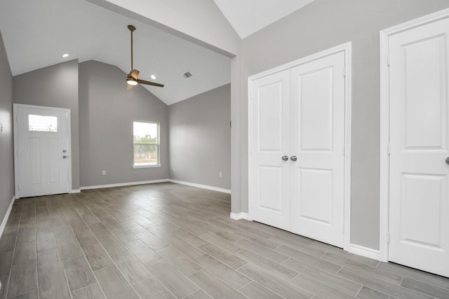 entrance foyer featuring ceiling fan, vaulted ceiling, and light hardwood / wood-style floors