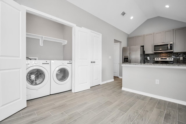 clothes washing area with separate washer and dryer