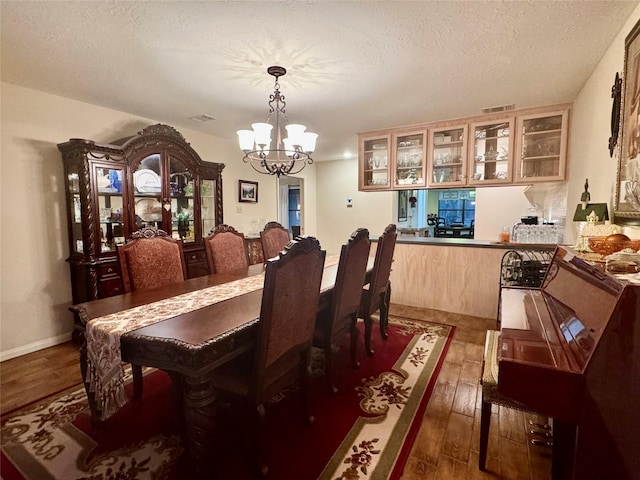 125 Clear Spgs, Trinity, TX 75862 - dining room featuring a chandelier, hardwood / wood-style floors, and a textured ceiling