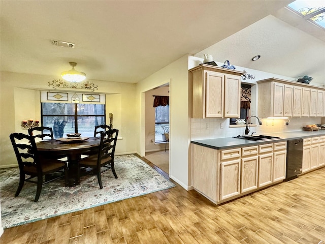 125 Clear Spgs, Trinity, TX 75862 - kitchen featuring a sink, dishwashing machine, light wood finished floors, and decorative backsplash