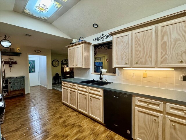 125 Clear Spgs, Trinity, TX 75862 - kitchen with black dishwasher, a sink, light brown cabinetry, lofted ceiling, and tasteful backsplash