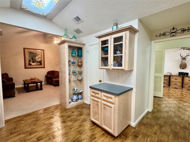 125 Clear Spgs, Trinity, TX 75862 - bar with dark wood-style flooring, baseboards, lofted ceiling, a skylight, and a textured ceiling