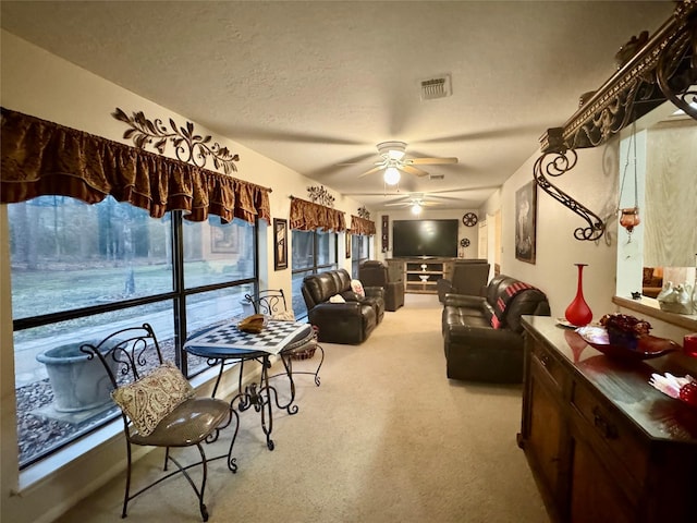 125 Clear Spgs, Trinity, TX 75862 - carpeted living room featuring ceiling fan and a textured ceiling